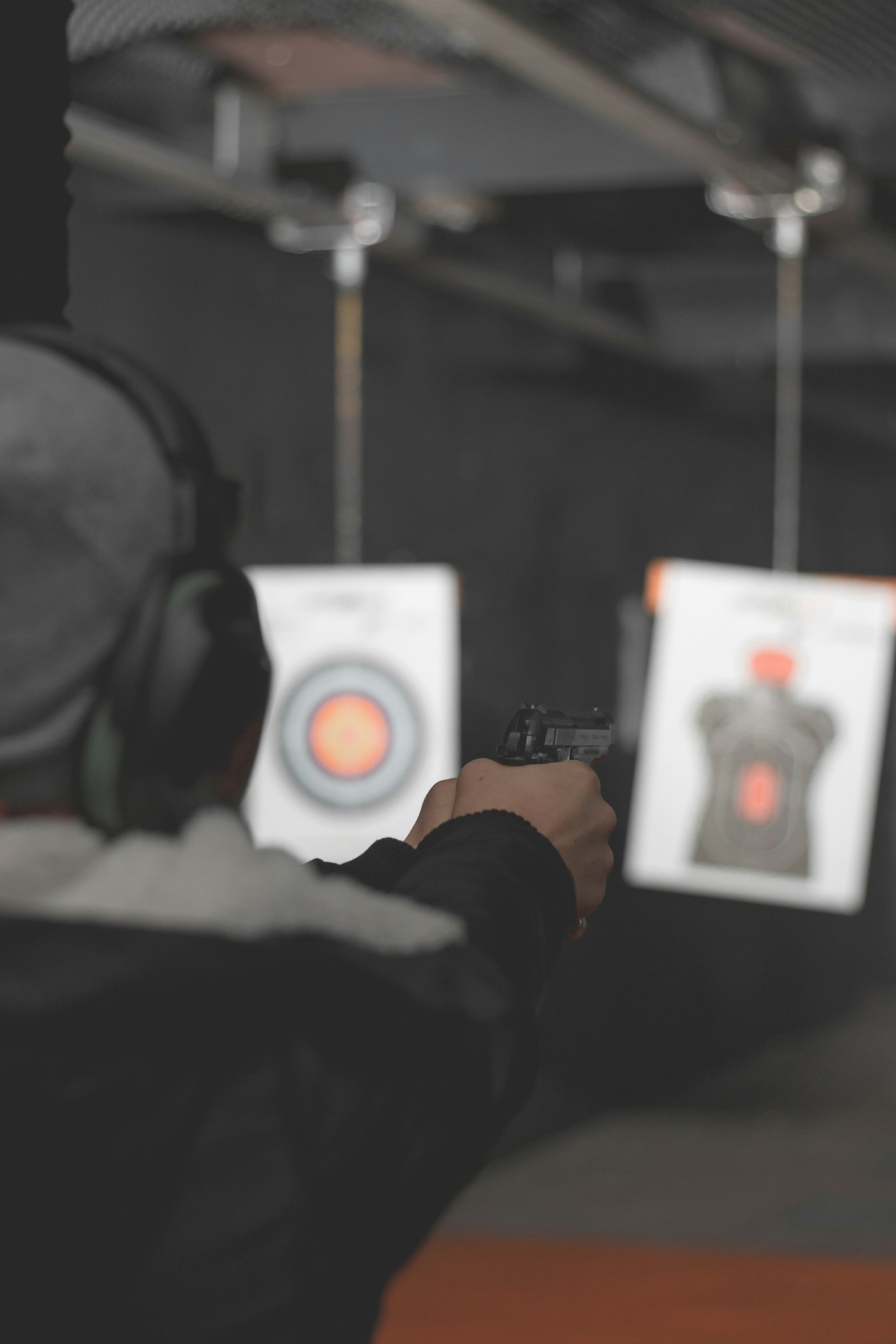 Student aiming at a paper target on an indoor range